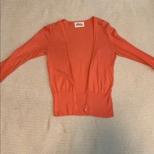Coral cardigan, quarter sleeved, with buttons.